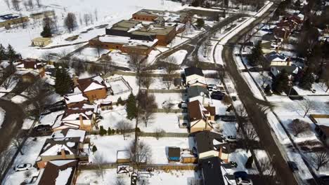 Aerial-view-of-two-neighbouring,-deserted-schools-yards,-on-a-wintery-day