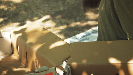 unrecognizable-Man-organizing-cardboard-boxes