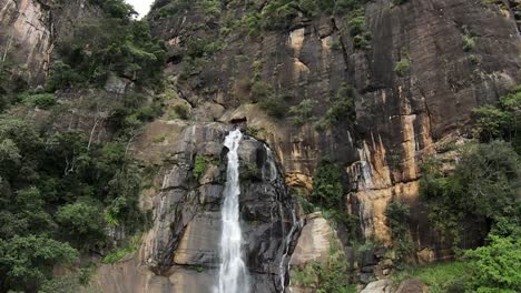 Slow-Motion-Coming-Into-Shot-Of-Waterfall-Flowing-From-Middle-Rocky-Mountain,-Sri-Lanka