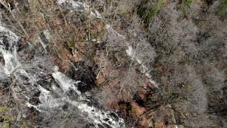 Dazzling-View-From-Above-Of-Ramhultafallet-Waterfall-Surrounded-By-Bare-Trees-In-Late-Winter-Near-Gothenburg-In-Sweden