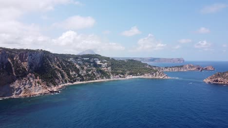 Mirador-Cap-Negre-Viewpoint-at-Javea,-Alicante,-Spain---Aerial-Drone-View-of-the-Coastline-with-Blue-Sea,-White-Beach-and-Islands