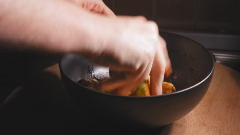 A-close-up-shot-of-the-hand-of-a-chef-mixing-spices-and-seasoning-to-his-freshly-prepared-brussels-sprouts,-spreading-the-seasoning-is-important-for-an-even-and-consistent-flavour