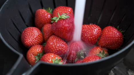 Fresh-ripe-red-Strawberries-being-washed-and-sprinkled-with-sugar-in-a-kitechen-environment