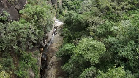 Top-down-cinematic-shot-of-Sri-Lanka-canyon-at-Ravana-Falls-in-South-Asia,-aerial-view