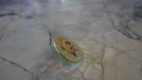 Doge-Coin-spinning-on-a-stone-counter-top