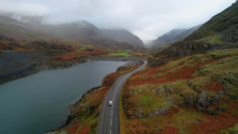 Narrow-Road-And-Brightly-Colored-Mountain-Scenery-Near-Dinorwic-Quarry---aerial-shot