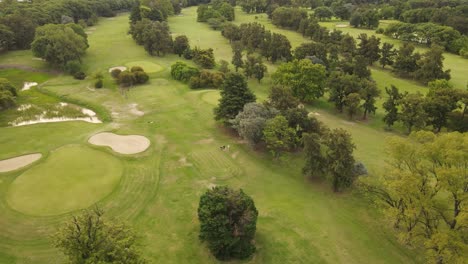 Couple-of-golfers-walking-on-verdant-golf-course,-Golf-Club-Buenos-Aires-in-Argentine