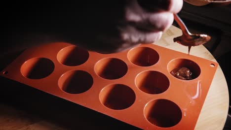 Plastic-Cupcake-Mold-Being-Filled-With-Choco-Banana-Cake-Batter-Mixture