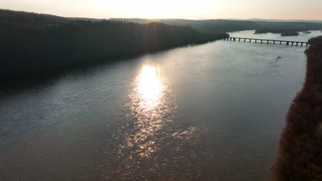 Aerial-of-bridge-across-river-in-winter-scene