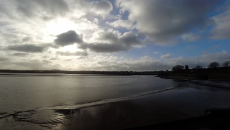 Sunrise-shimmering-river-Mersey-estuary-time-lapse-clouds-passing-over-Runcorn-town-skyline