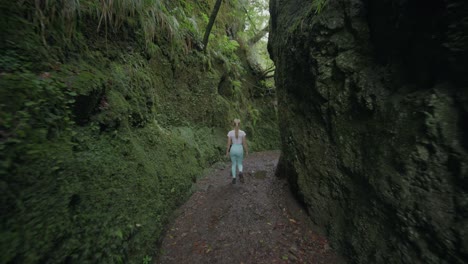 Attractive-sporty-blond-woman-hiking-through-Balcoes-canyon-in-Madeira