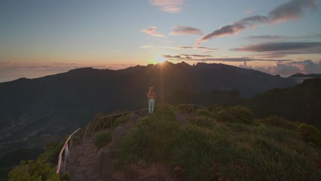 Fit-hiking-woman-in-sportswear-staring-at-dreamy-sunrise-on-mountain-top