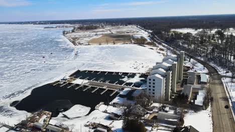 Aerial-tracking-over-an-apartment-building-on-the-freezing-shores-of-Muskegon-Lake