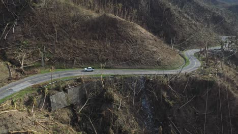 Lone-Vehicle-Driving-Across-The-Mountainside-Road-In-The-Affected-Area-Of-Typhoon-Odette-In-Southern-Leyte,-Philippines
