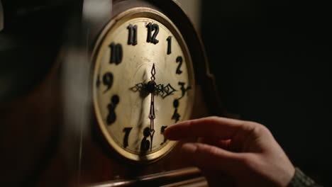 Hand-changes-time-on-an-old-mechanical-clock