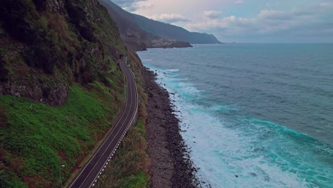 Drone-flying-fast-on-the-north-side-of-Madeira-island,-tilting-into-the-horizon