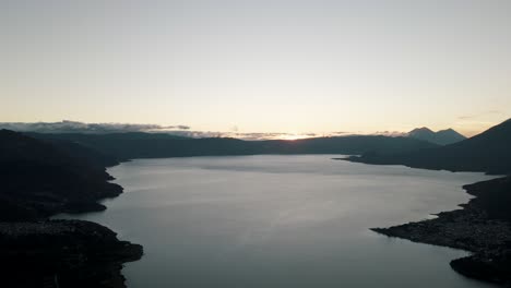 Still-Lake-Water-And-Majestic-Mountain-Silhouette-Of-Rostro-Maya-In-Sundown---Aerial-shot