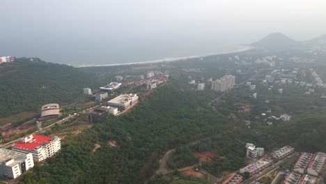 beautiful-view-in-vishakhapatnam-green-tress-and-beautiful-sea-Sunrise-Startup-Village,-Startup-Village,-Pedda-Rushikonda,-Rushikonda,-Visakhapatnam,-Andhra-Pradesh-drone-shot-air-view-birds-eye