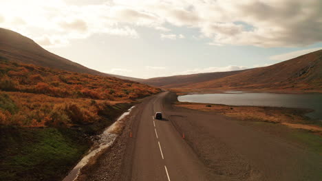 Scenic-View-Of-Car-Driving-On-Oxi-Mountain-Road-During-Sunset-In-East-Iceland