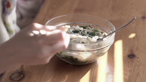 Close-up-video-grabbing-and-eating-meatballs-from-a-very-hot-asian-soup-using-chopsticks