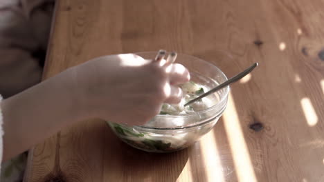 Close-up-young-woman-hands-using-chopsticks-to-eat-chinese-noodles-for-breakfast