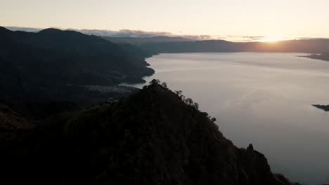 Dawn-horizon-of-Lake-Atitlan-from-the-heights-of-Indian-Nose,-Guatemala---Aerial-orbit-shot