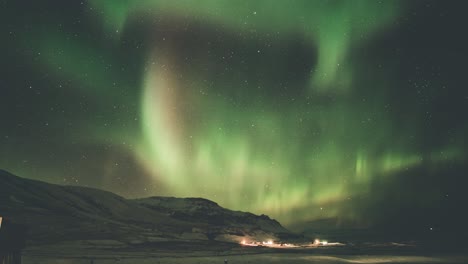 Timelapse-of-the-aurora-borealis-moving-over-mountains-and-open-fields-in-south-Iceland