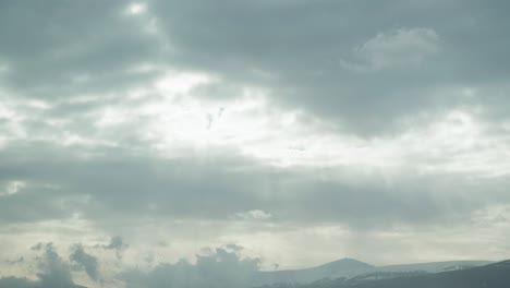 Sun-rays-through-rain-clouds-over-the-Sniezka-Mountain-in-Poland---Time-lapse