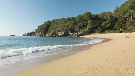 Calm-waves-on-a-beautiful-empty-natural-beach-in-Costa-brava-coastline,-Spain