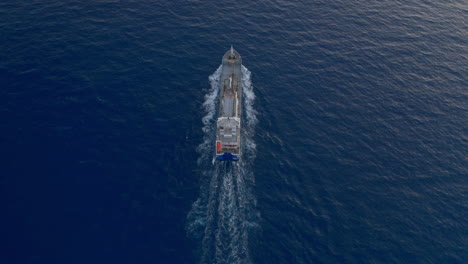 Aerial-follow-footage-of-cargo-ship-in-calm-sea