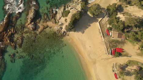 Top-down-view-empty-paradise-beach-with-very-clean-water,-Santa-Cristina-Spain