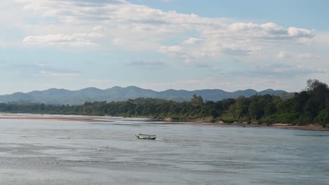 Navigating-Mekong-River-going-up-stream-this-touring-boat-is,-Thailand-and-Laos