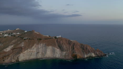 Aerial-view-of-Akrotiri-lighthouse-in-Santorini,-Greece-during-dusk