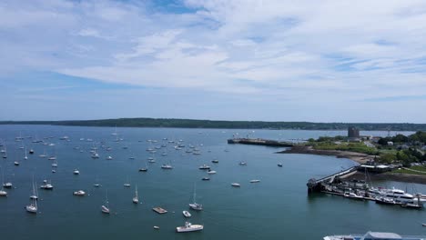 Boats-Docked-in-Bay-at-Rockland-Harbor,-Maine-|-Aerial-View-Panning-Up-|-Summer-2021