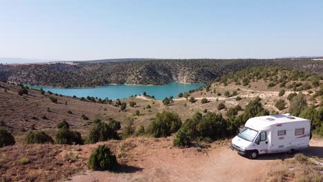 Embalse-del-Arquillo-de-San-Blas,-Teruel,-Aragon,-Spain---Aerial-Drone-View-of-a-Motorhome-Sleeping-Spot-at-the-Dam-Lake-and-Turquoise-Water-Reservoir