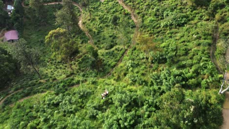 Aerial-tracking-shot-of-unrecognizable-person-in-zip-line,-Sri-Lanka