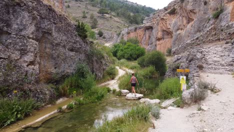 Ruta-del-Barranco-de-la-Hoz-in-Calomarde,-Teruel,-Guadalajara,-Spain---Tourist-Girl-Walking-the-Beautiful-Hike-through-the-Canyon