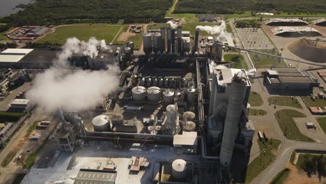 Smoke-pollution-from-paper-mill-factory,-rotating-aerial-view