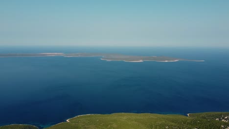 aerial-of-Croatian-island-Unije-seen-from-Losinj-island,-flying-right