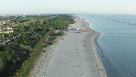 Aerial-shot-of-sandy-beach-with-umbrellas-and-adriatic-sea,-typical-Emilia-Romagna-shore