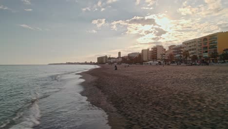 Benalmadena-aerial-beach-dolly-at-sunset,-south-of-Spain