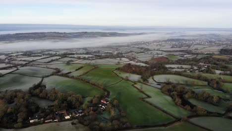 Aerial-backwards-shot-of-the-Devon-Countryside-England-on-a-misty-morning