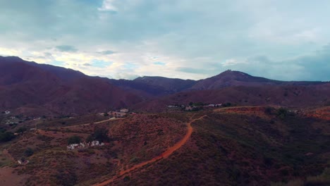 Drone-flying-backwards-on-a-cloudy-day-on-the-mountains