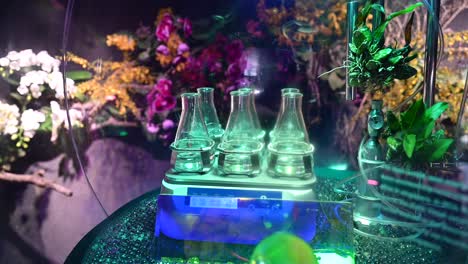 4K:-Laboratory-flasks-with-transparent-liquid-Substances,-Plant-and-flower-laboratory,-Agriculture-experiments-concept-inside-Plants-Nursery