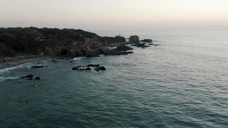 Cliffs-And-Ocean-Rocks-In-Puerto-Escondido-At-Sunset---aerial-drone-shot