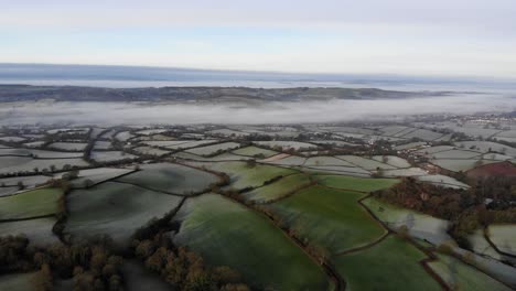 Aerial-panning-right-shot-of-the-Otter-Valley-in-Devon-England-on-a-frosty-morning