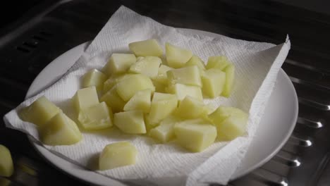 Boiled-Potatoes-Drying-on-Paper-Before-Being-Fried-in-Pan,-Cooking-Vegetarian