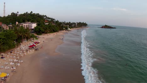 Areal-Shot-Of-Big-Wave-Splashing-Smoothly-On-Sandy-Beach-On-Sunny-Day,-Sri-Lanka