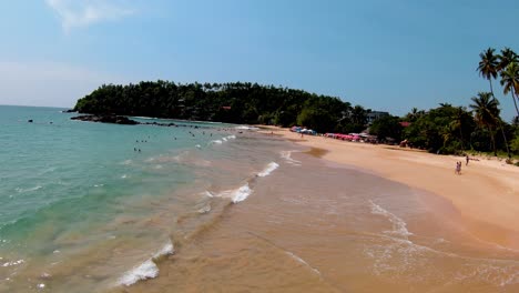 überholen-Sie-Den-Schuss-Des-Tropischen-Meeres-Und-Der-Glänzenden-Goldenen-Wellen-Spritzen-Am-Strand,-Sri-Lanka