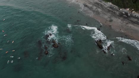 Aerial-View-Of-Beach-With-Surfers-In-Puerto-Escondido,-Oaxaca,-Mexico---drone-top-down